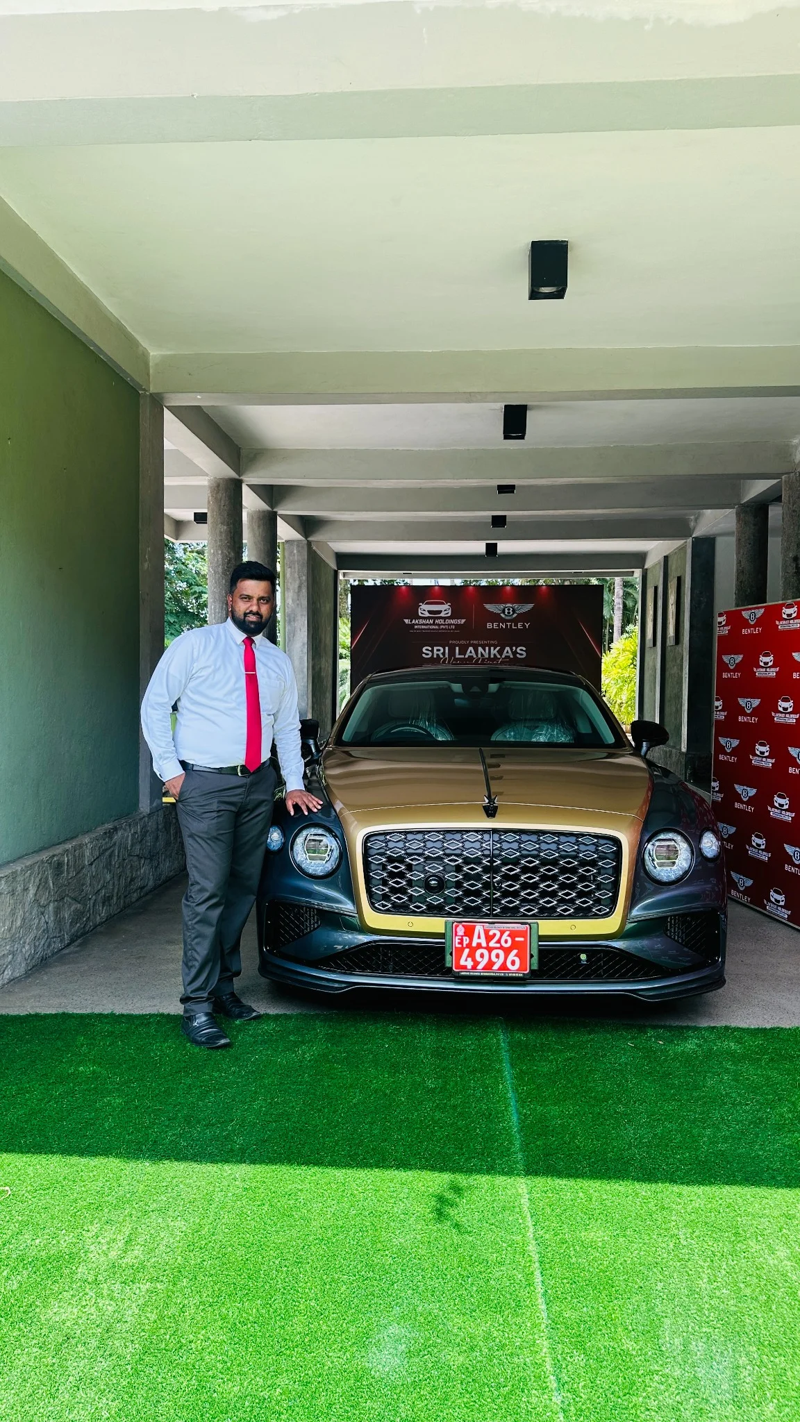 Keshara beside the two-tone Bentley